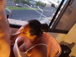 Bbw milf blowing cock in front of a window